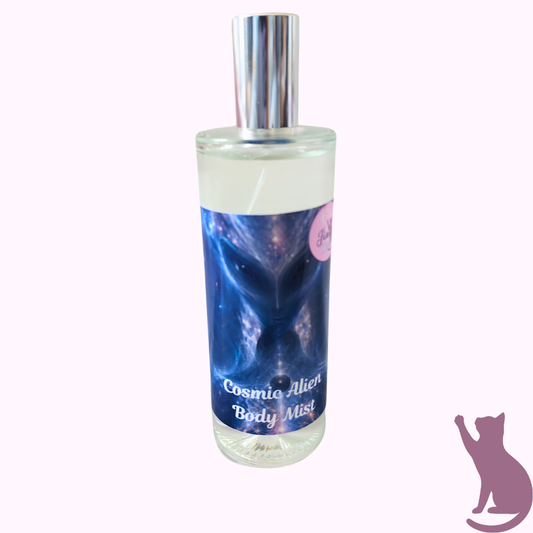 Cosmic Alien Body Mist in a clear glass bottle with a silver spray cap, featuring a blue and purple alien-themed label, set against a pale pink background.
