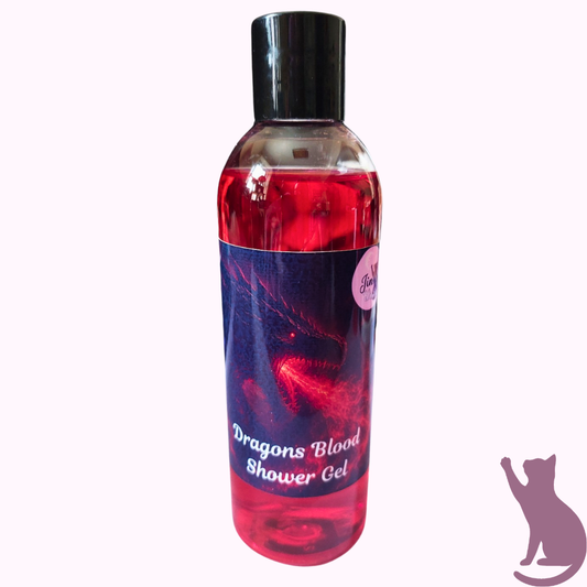 A bottle of Dragon's Blood Shower Gel with a black cap and a dark blue label featuring red dragon artwork, shown against a pale pink background.