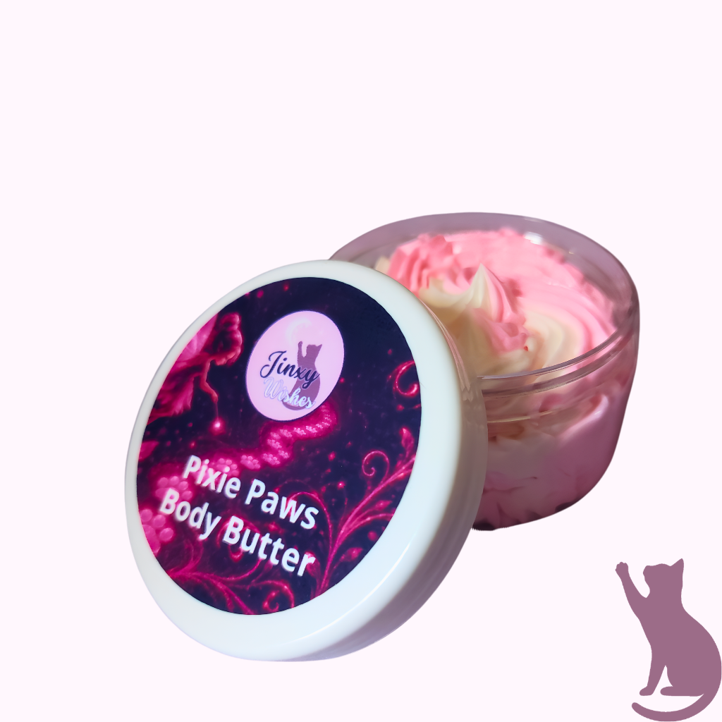 A jar of Pixie Paws Body Butter with its lid leaning against it, showing pink and white whipped body butter inside. The lid features a white rim and a dark purple label with pink swirls