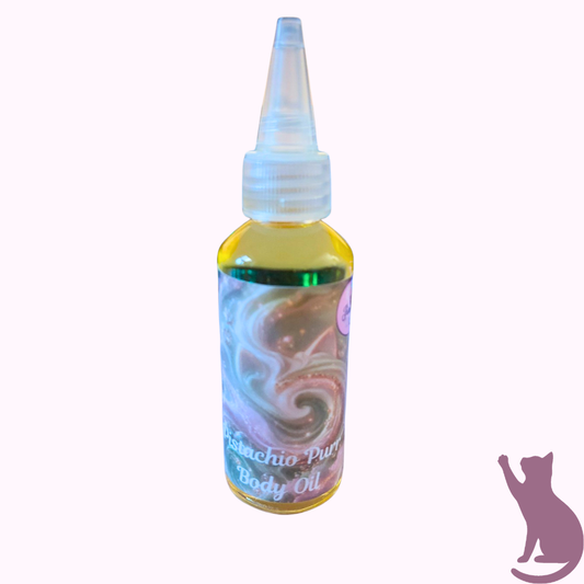 A small bottle of body oil with a pointed applicator cap, shown on a plain light background. The bottle contains yellow oil and has a colorful swirling label with pastel tones and the text 'Pistachio Purr Body Oil.